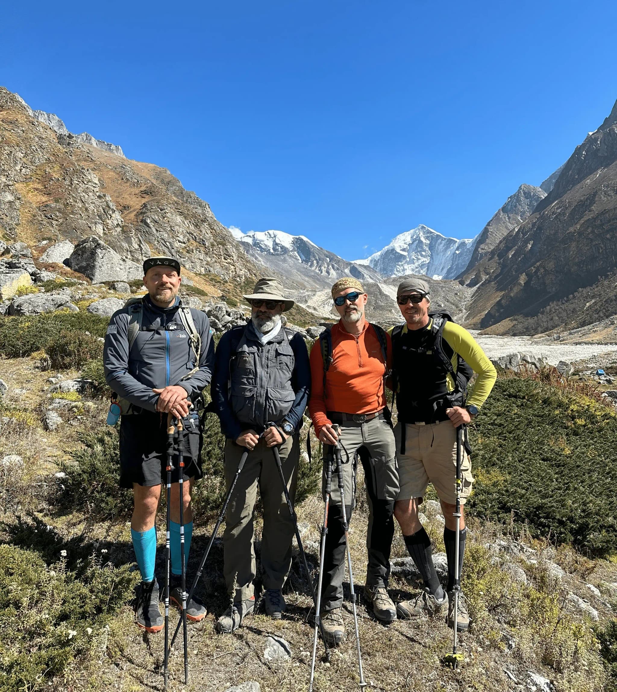 Rajiv Tomar with trekkers in a Himalayan valley below the snow peaks