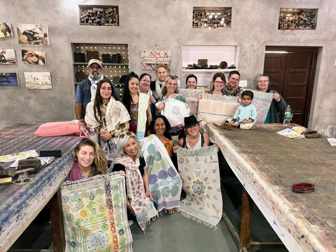 Travellers with hand block-printed textiles at an artisan studio