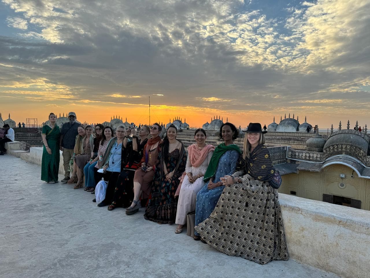 Guests watching the sun set over domed rooftops