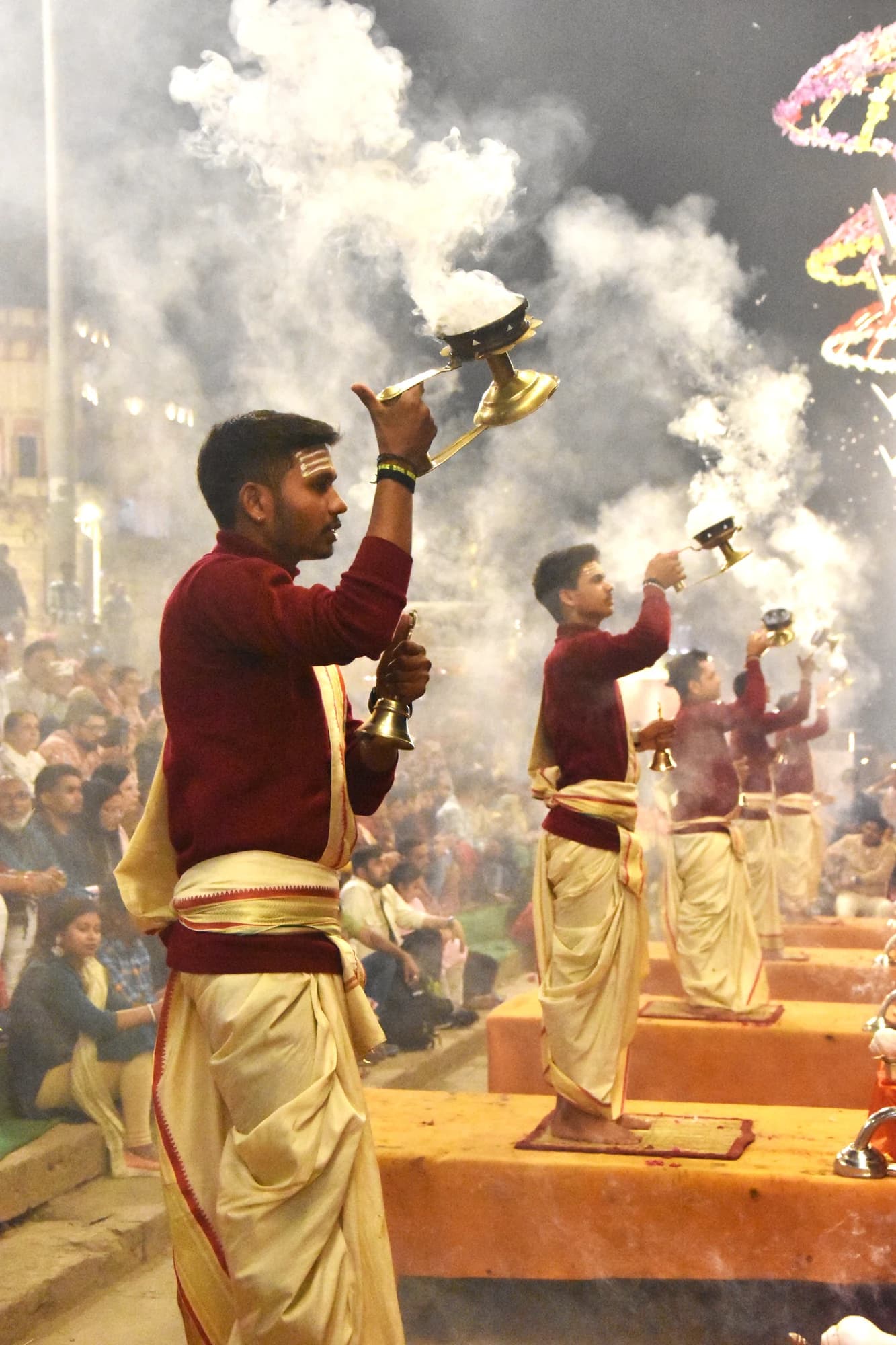 A priest raising the aarti lamp