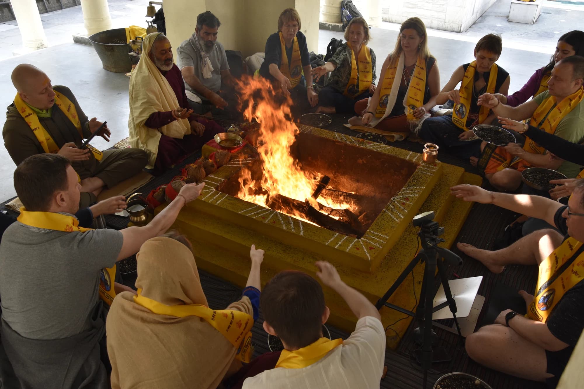 Pilgrims seated around a havan fire