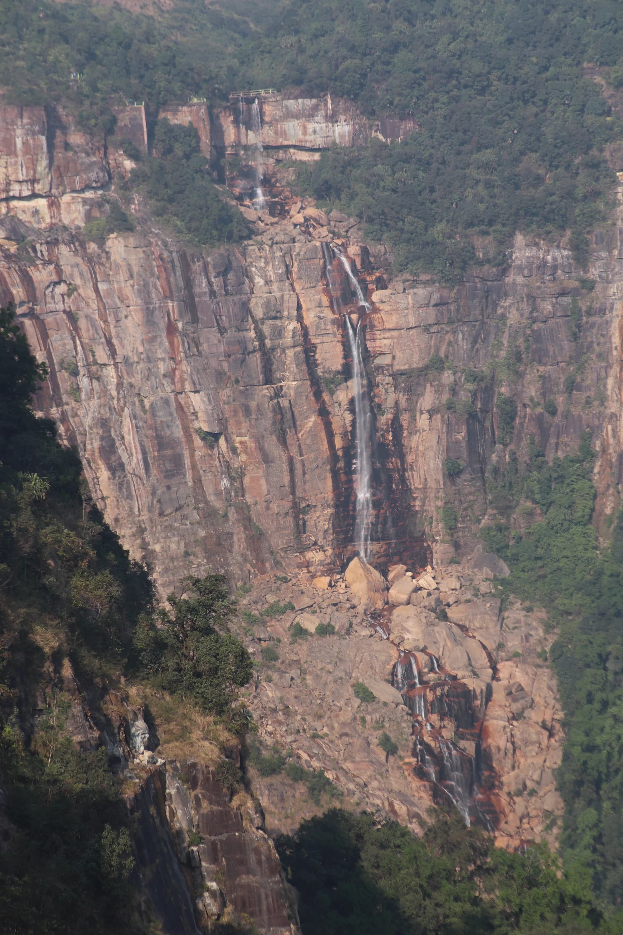 A waterfall dropping down a sheer cliff face in Meghalaya