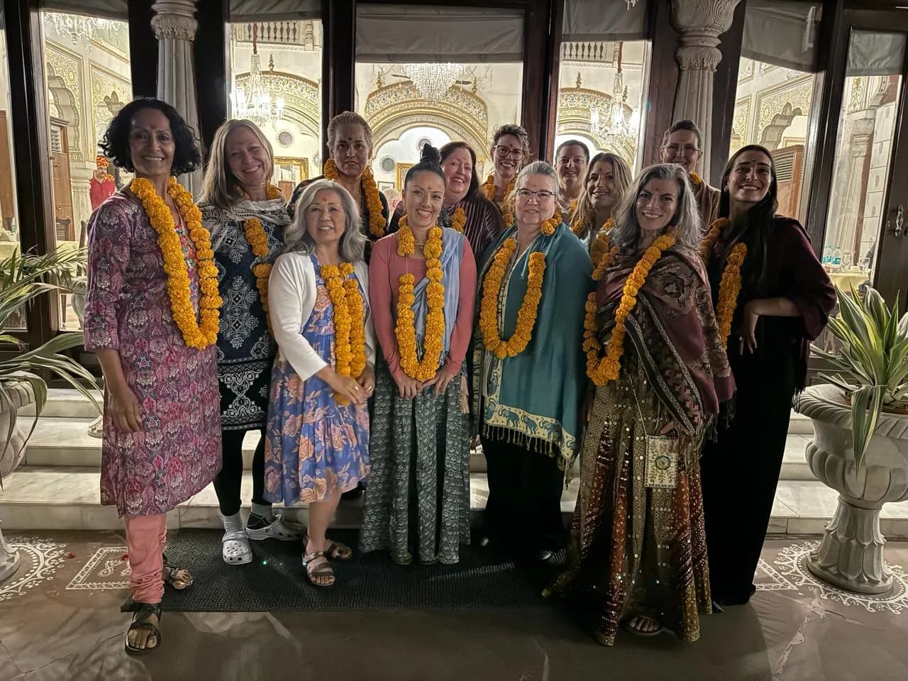 Guests wearing marigold garlands at a heritage hotel welcome