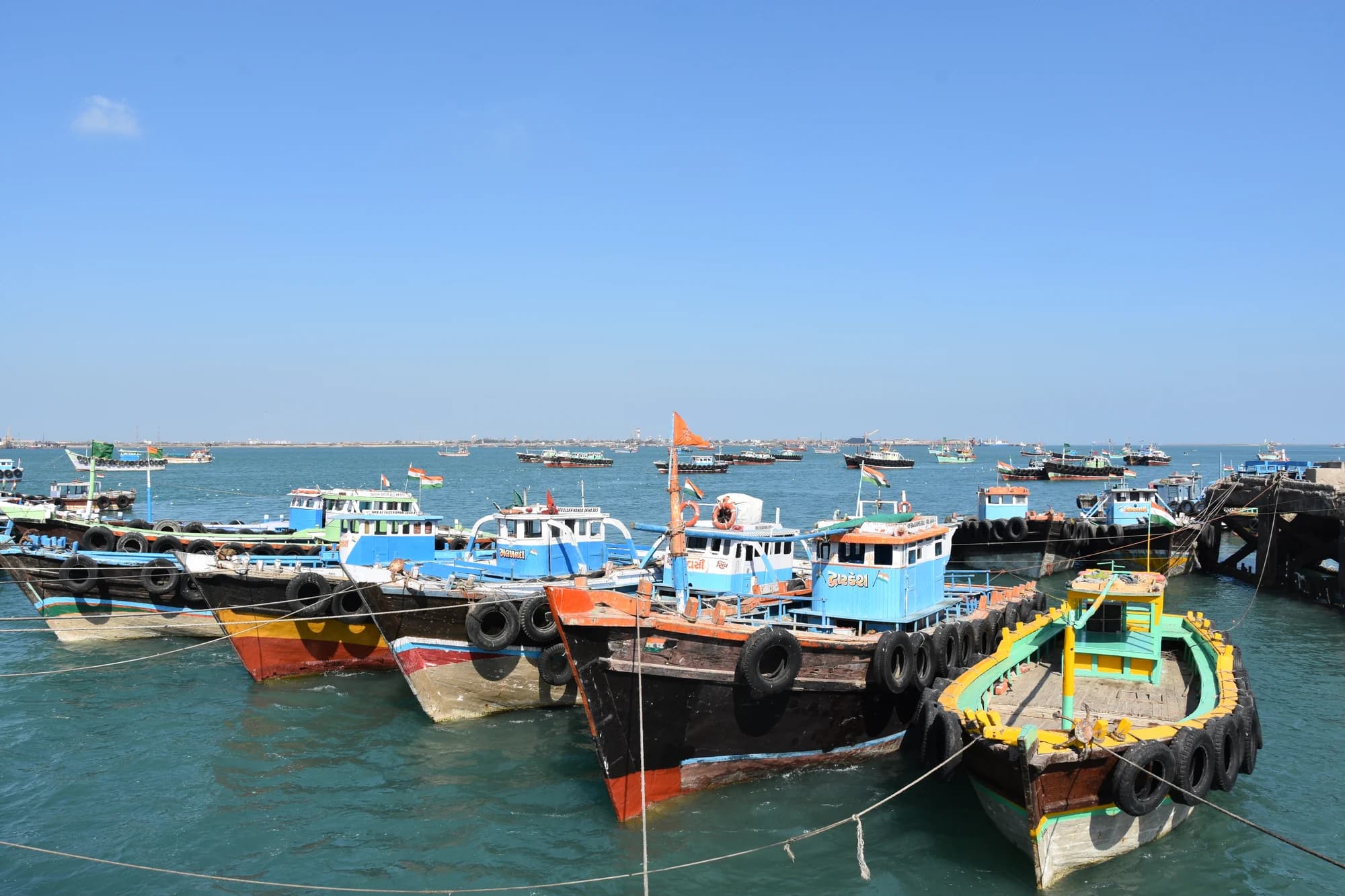 Colourful wooden boats moored at the jetty for Bet Dwarka