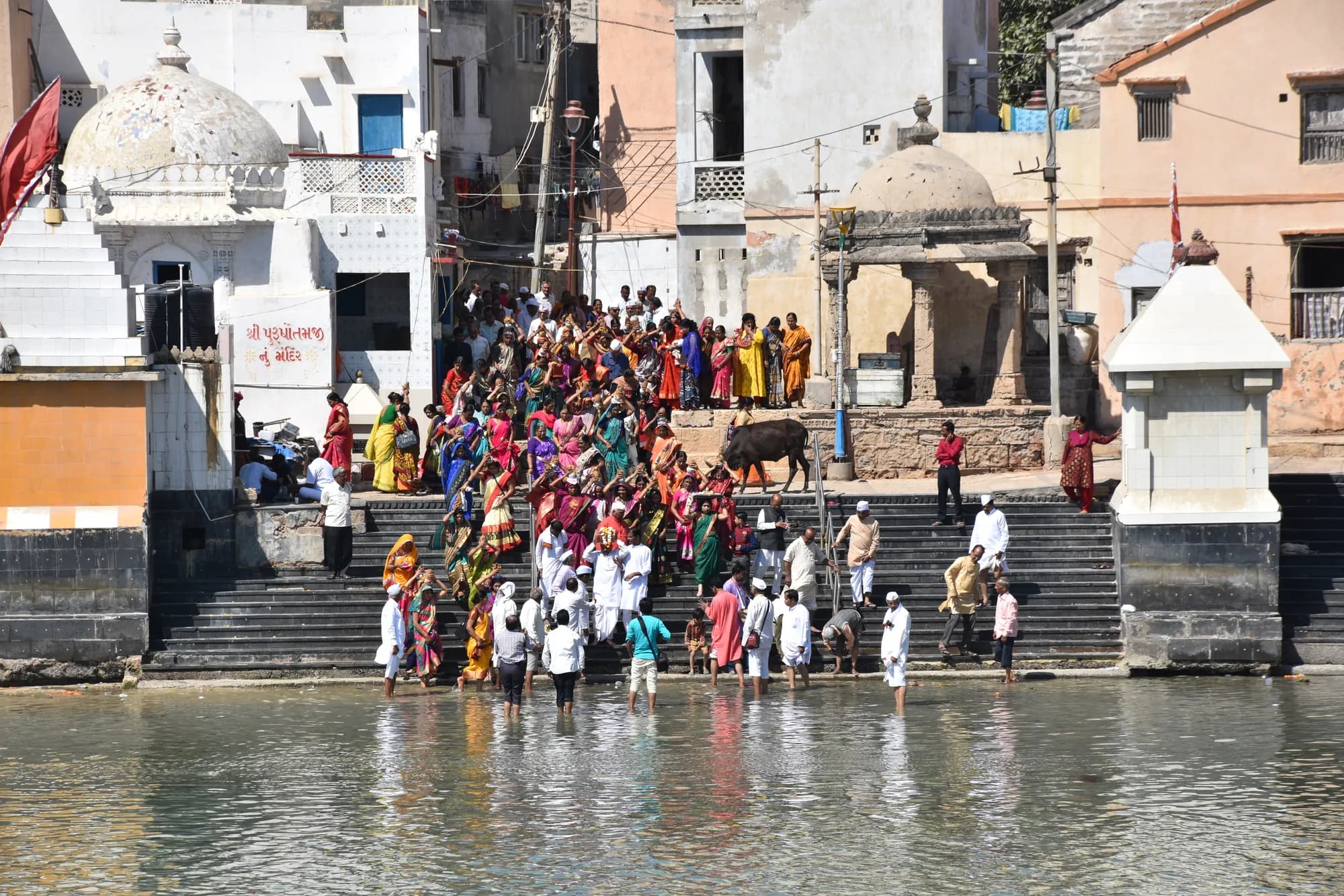 Pilgrims bathing at the steps of Gomti Ghat in Dwarka