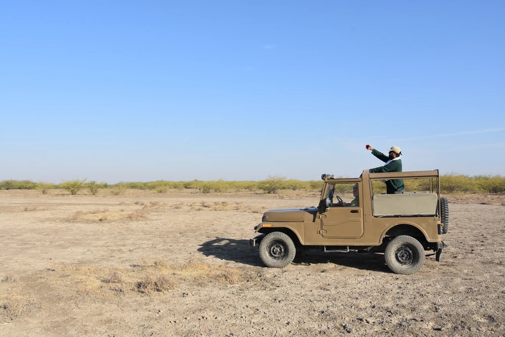 A safari jeep on the open salt flats of the Little Rann of Kutch